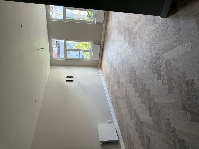 Lichte leefruimte met visgraat parket na renovatie